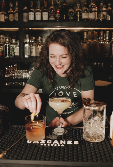 A bartender garnishing cocktails at Smith's on 7th